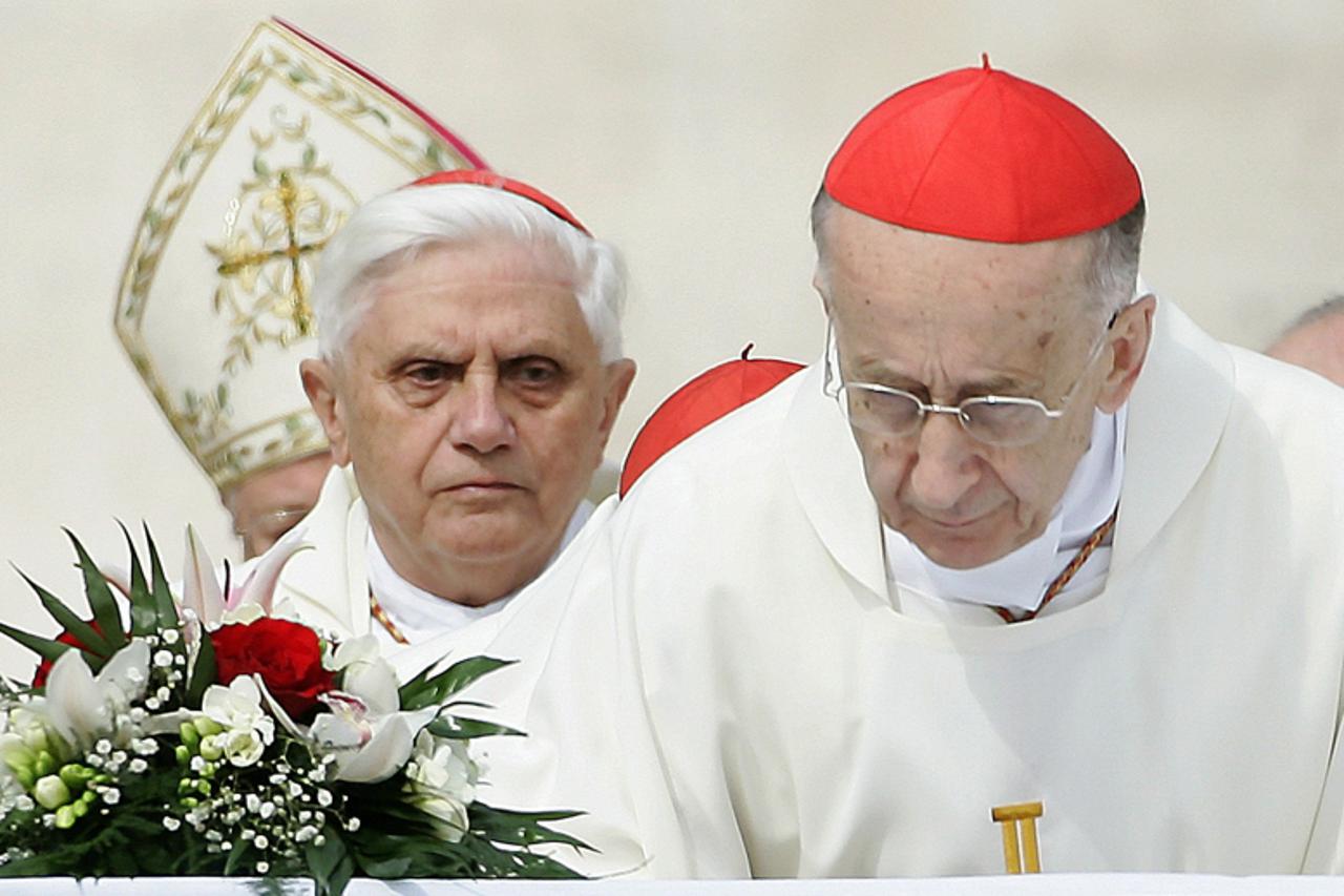 'German Cardinal Joseph Ratzinger (L) looks at Italian Cardinal Camillo Ruini as they kiss the altar before the start of a solemn mass, led by Italian Cardinal Angelo Sodano, for the death of Pope Joh