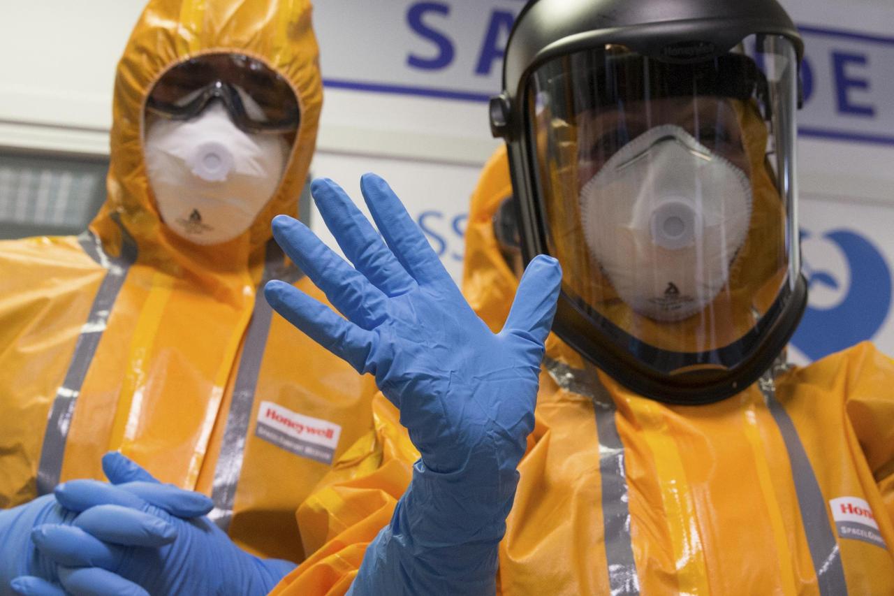 Staff of the emergency medical services in France (SAMU) wear Ebola virus protection outfits during a press presentation at the Necker Hospital in Paris, October 24, 2014. European Union leaders agreed on Friday to roughly double their financial support f