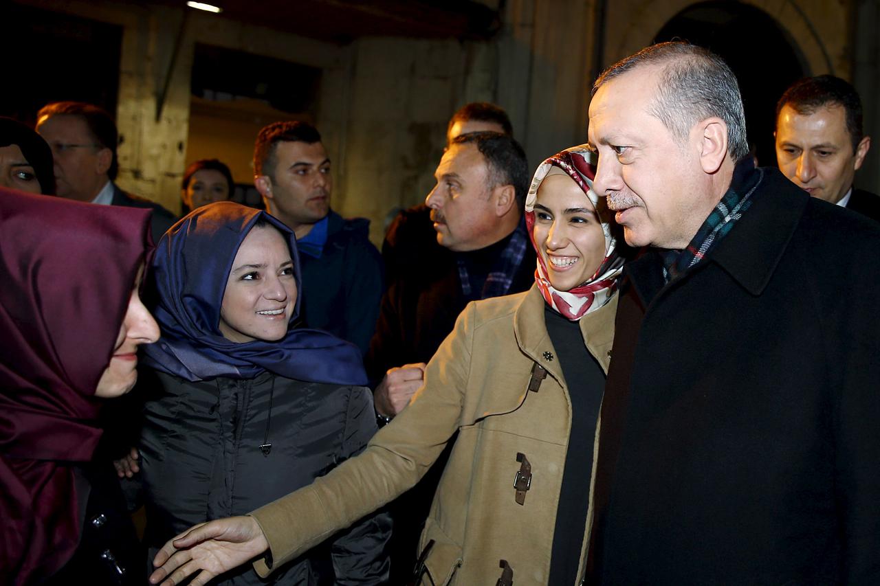 Turkish President Tayyip Erdogan, accompanied by his daughter Sumeyye Erdogan (2nd R), chats with his supporters following morning prayer, at the courtyard of Eyup Sultan mosque in Istanbul, Turkey, November 2, 2015 in this handout photo provided by Presi