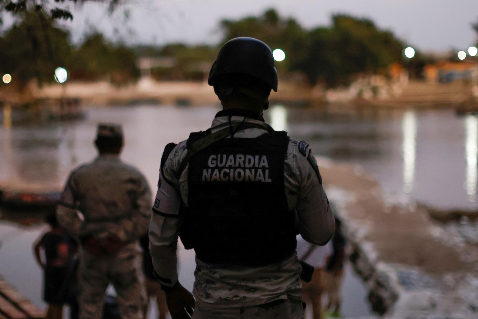 Members of the National Guard keep watch at the banks of the Suchiate river, while they guard the border to prevent a migrant caravan of Central Americans from entering, in Ciudad Hidalgo Members of the National Guard keep watch at the banks of the Suchiate river, the natural border between Mexico and Guatemala, while they guard the border to prevent a migrant caravan of Central Americans from entering, in Ciudad Hidalgo, Mexico January 17, 2021. REUTERS/Carlos Jasso CARLOS JASSO
