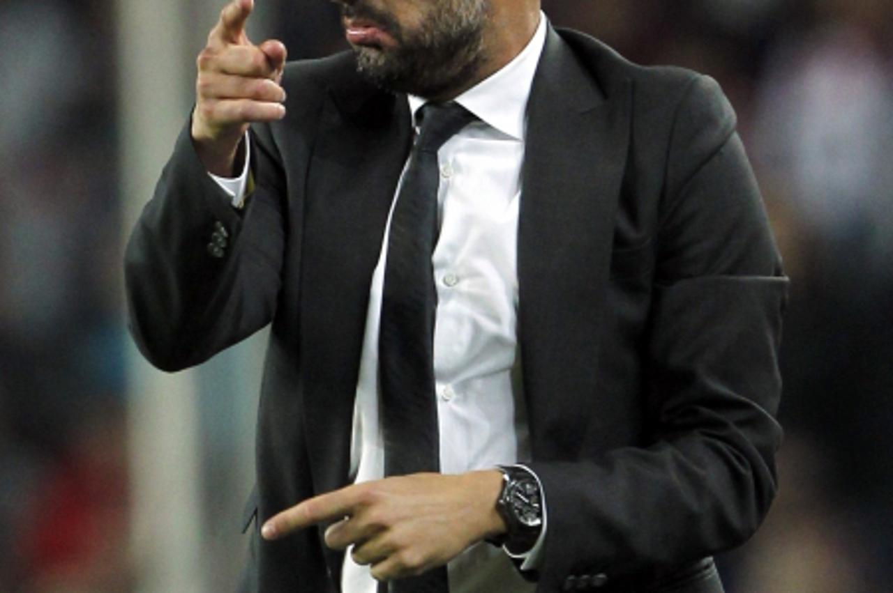 'Barcelona's coach Pep Guardiola gestures during their Spanish First division soccer league match against Mallorca at Camp Nou stadium in Barcelona October 29, 2011. REUTERS/Albert Gea (SPAIN - Tags: