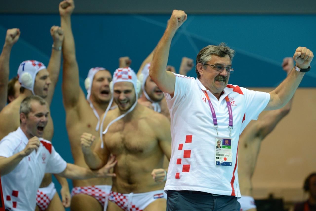 'Croatia\'s coach Ratko Rudic (R) celebrates after the men\'s water polo gold medal match Croatia vs Italy at the London 2012 Olympic Games in London on August 12, 2012.      AFP PHOTO / ADEK BERRY  '
