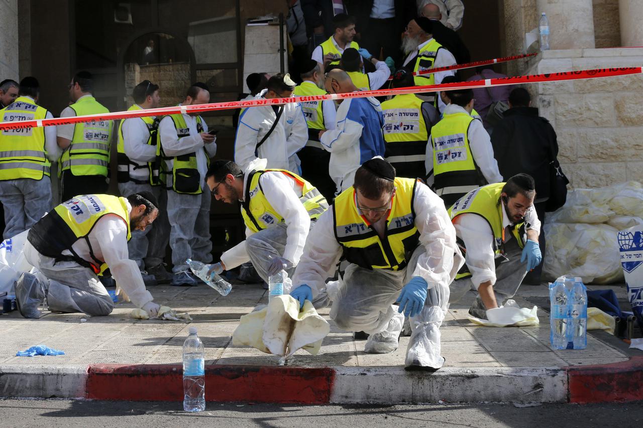 Members of the Israeli Zaka emergency response team clean blood from the scene of an attack at a Jerusalem synagogue November 18, 2014. Two suspected Palestinian men armed with axes and knives killed four people in a Jerusalem synagogue on Tuesday before 