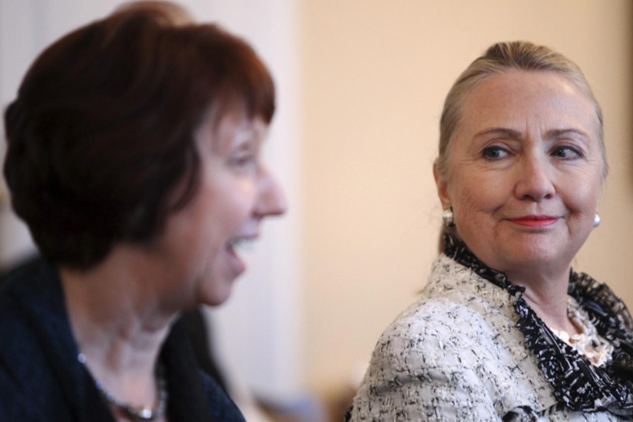 'U.S. Secretary of State Hillary Clinton (R) watches as European Union foreign policy chief Catherine Ashton (L) speaks before a meeting with the Bosnian presidency in Sarajevo October 30, 2012. REUTE