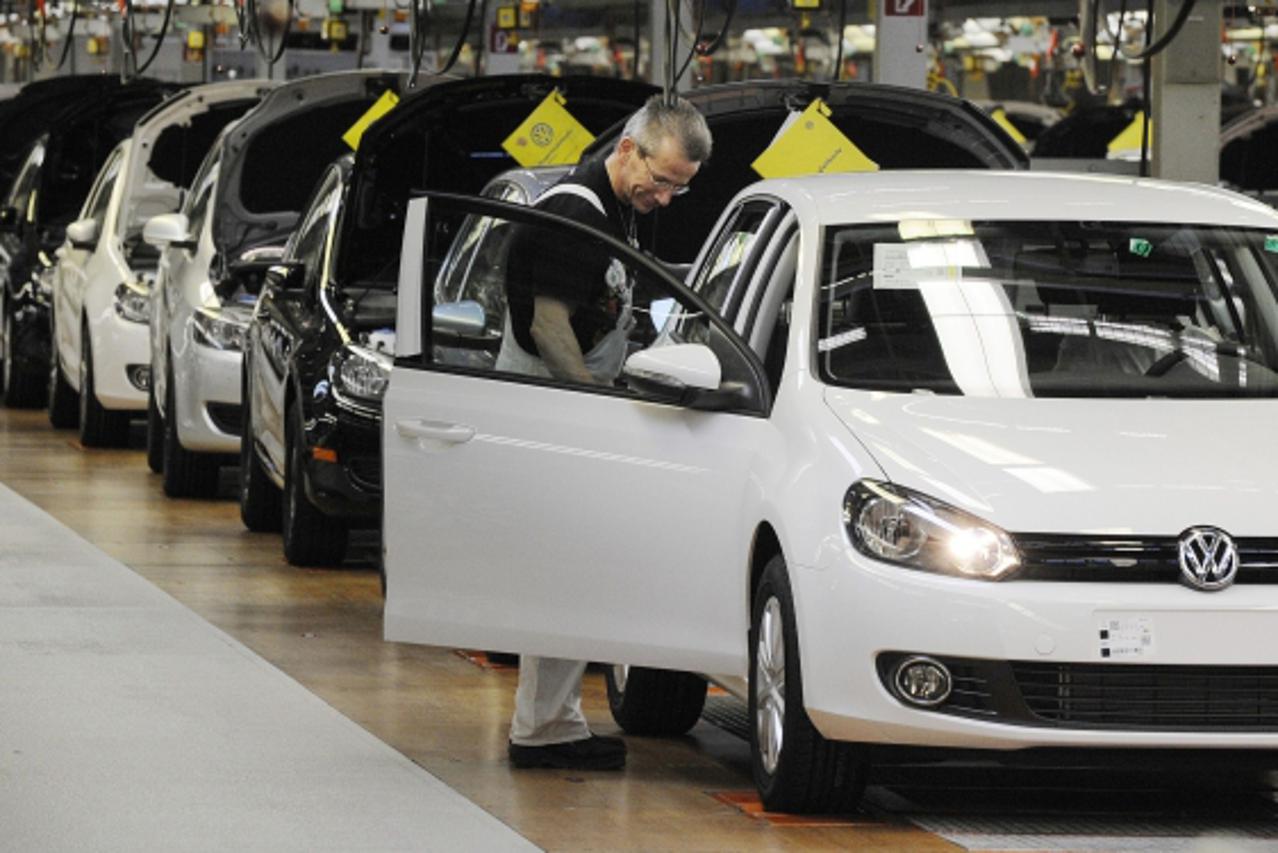 'Employees of German car manufacturer Volkswagen (VW) check VW Golf cars on March 8, 2010 at the main plant in Wolfsburg, northern Germany. Volkswagen holds its annual results 2009 press conference on