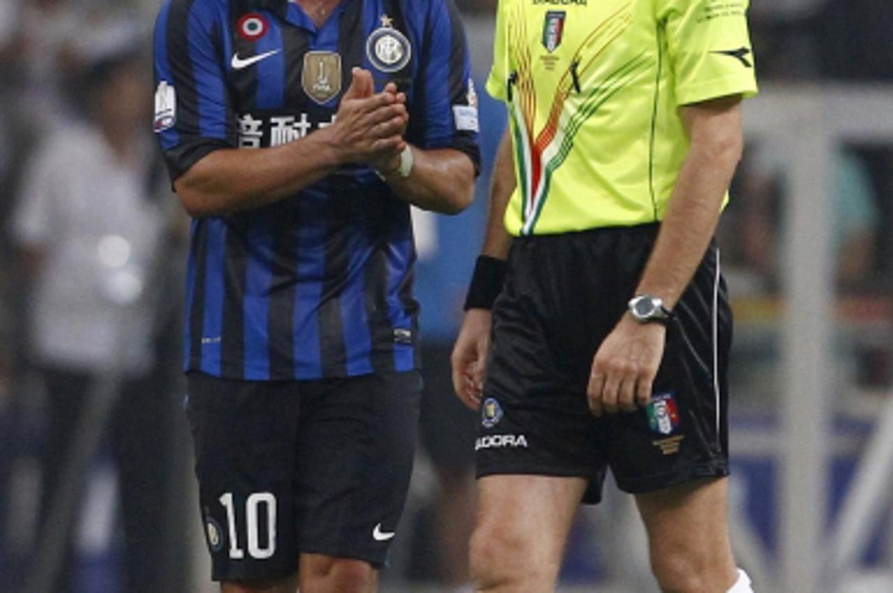 'Inter Milan\'s Wesley Sneijder (L) argues with referee Nicola Rizzoli during the Italian Super Cup soccer match against AC Milan at the National Olympic Stadium, also known as the Bird\'s Nest, in Be