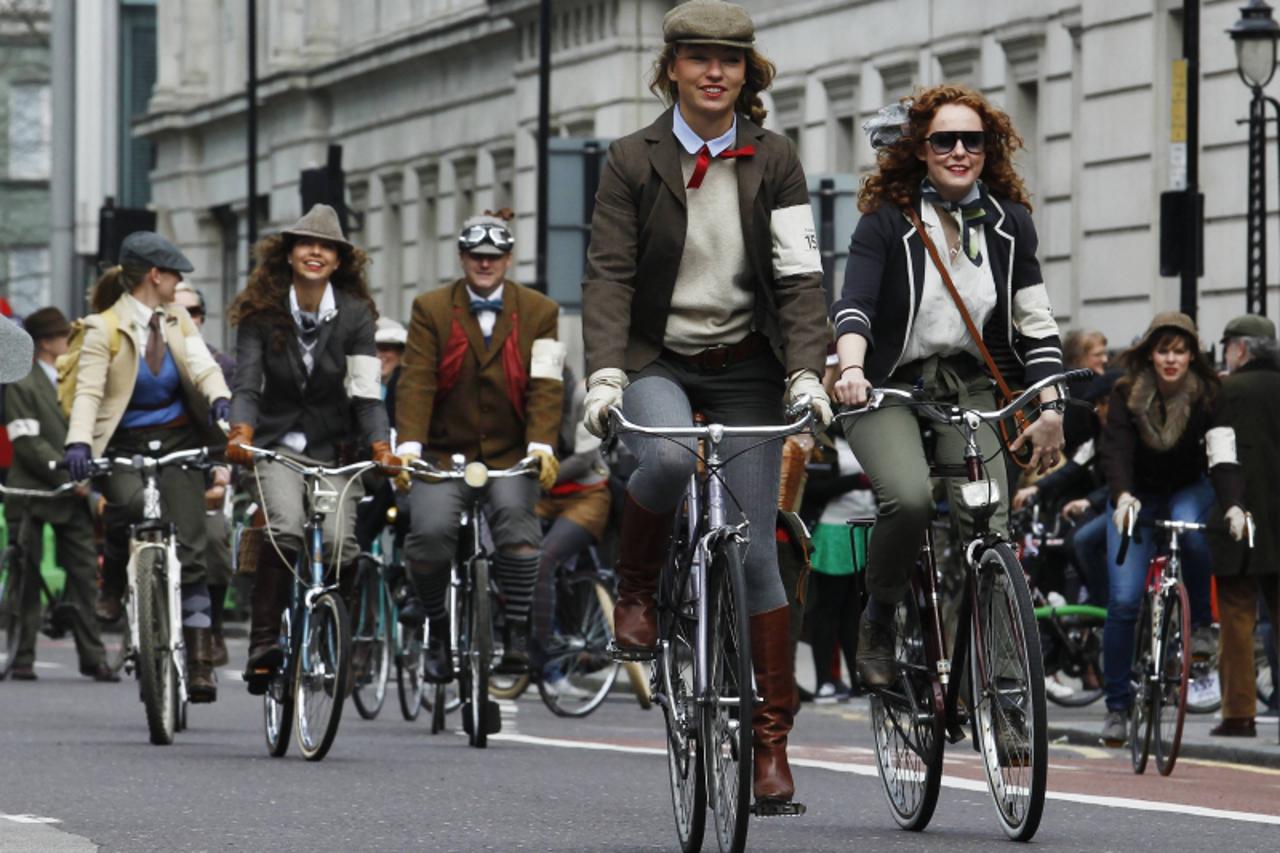 'People take part in the Tweed Run cycle ride in London April 13, 2013. Participants dress in tweed and are encouraged to ride old style bicycles during the annual ride through central London. REUTERS