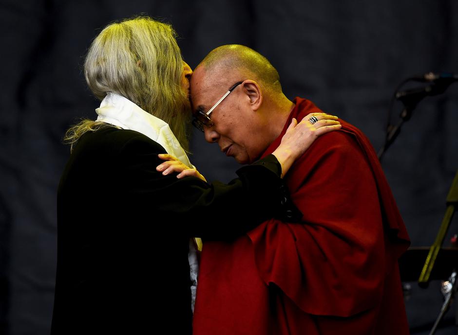 FILE PHOTO: Patti Smith kisses the Dalai Lama as she performs on the Pyramid stage at Worthy Farm in Somerset during the Glastonbury Festival