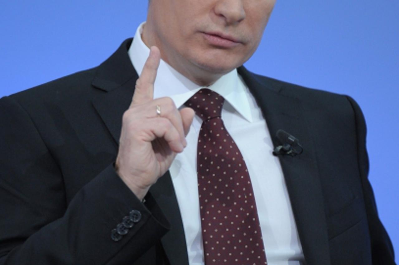 'Russia\'s Prime Minister Vladimir Putin gestures during his annual phone-in session with Russians in Moscow, on December 15, 2011. The carefully stage-managed annual phone-in, which allows Putin to f