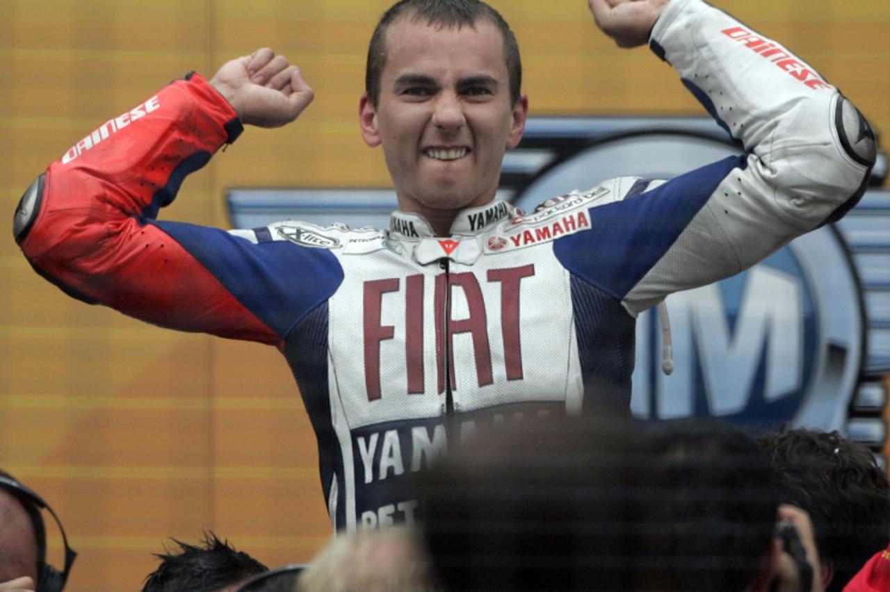 'Yamaha MotoGP rider Jorge Lorenzo of Spain celebrates after the Malaysian Grand Prix in Sepang, October 10, 2010. Lorenzo clinched his maiden MotoGP world title with a third-place finish at the Malay