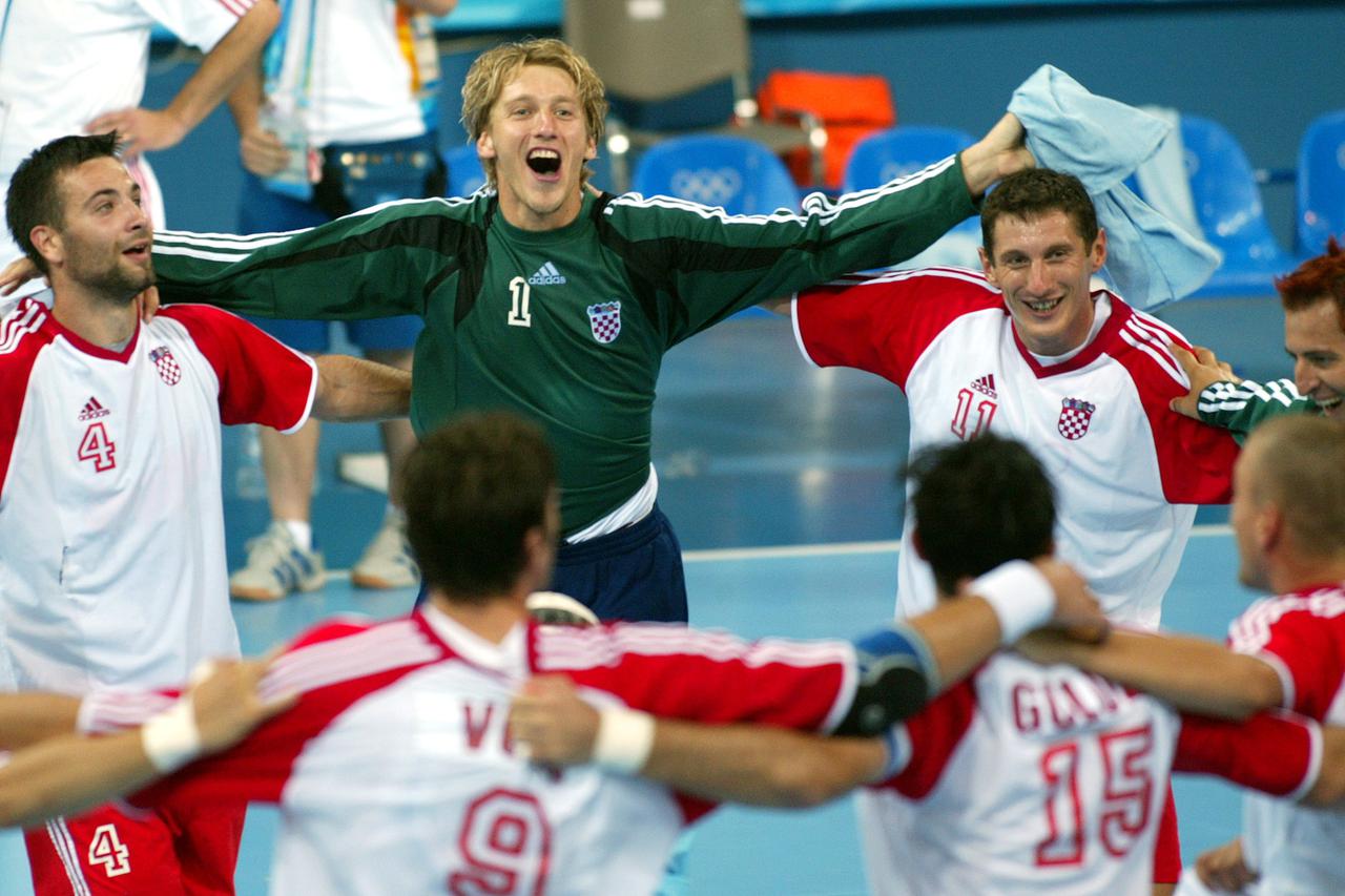 Croatia's men's handball team, including from L-R, Ivano Balic, Venio Losert, and Mirza Dzomba form a circle with team mates as they celebrate their quarter-finals win against Greece at the Athens 2004 Olympic Games August 24, 2004. Croatia defeated Greec