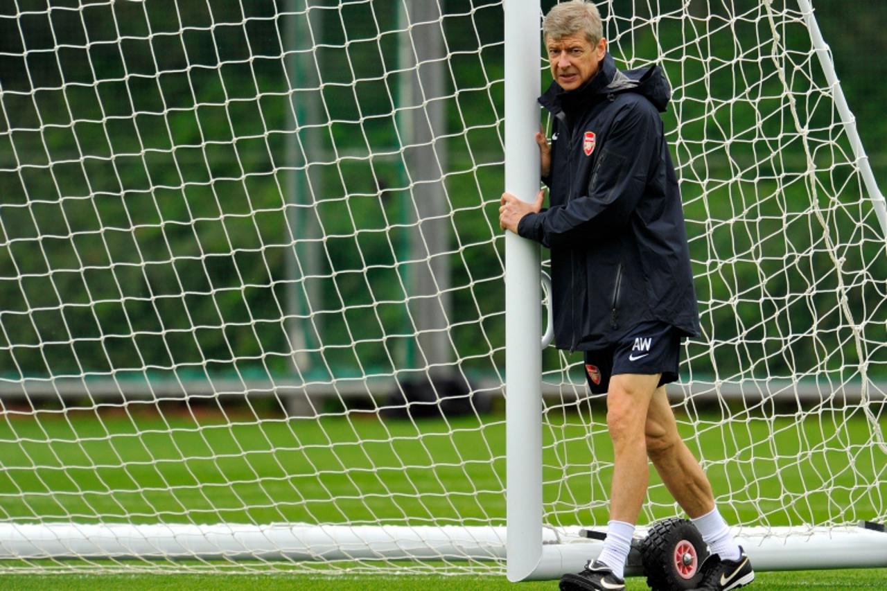 \'Arsenal\'s French manager Arsene Wenger moves a goal during a team training session at their London Colney training ground, in central England on September 14, 2010.  Arsenal are set to play Braga i