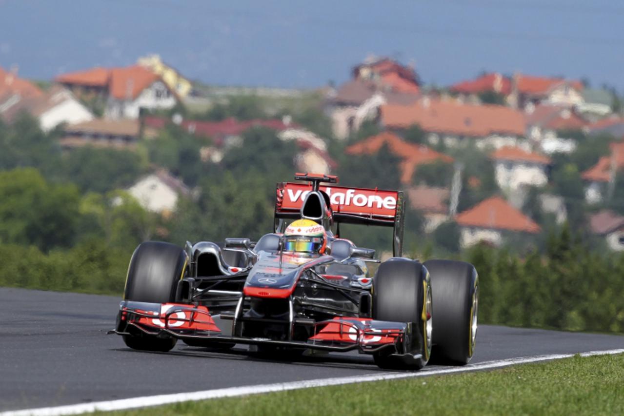 'McLaren Formula One driver Lewis Hamilton of Britain drives during the third practice session of the Hungarian F1 Grand Prix at the Hungaroring circuit near Budapest July 30, 2011 REUTERS/Bernadett S