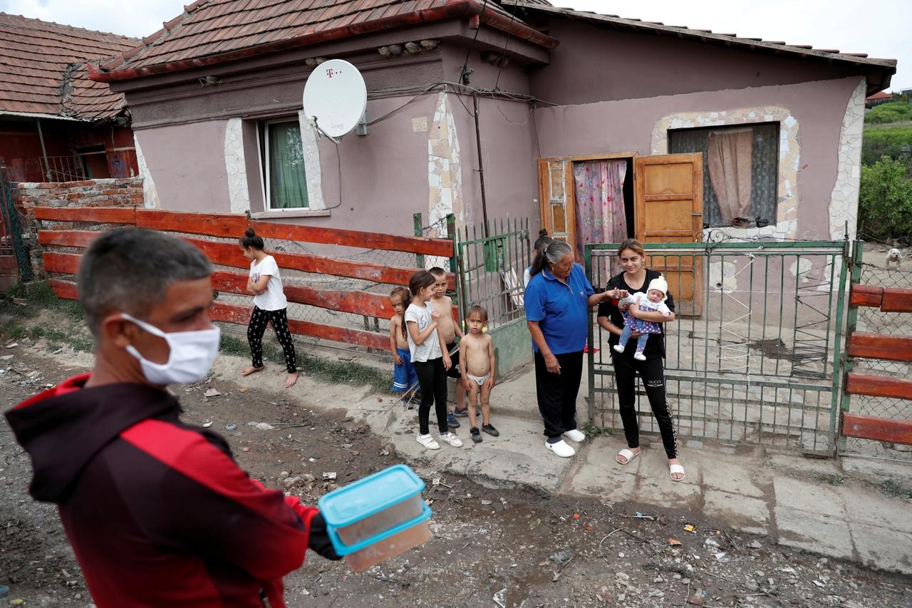 FILE PHOTO: A Roma activist carries food for donation to families in a deprived Roma neighbourhood during the coronavirus outbreak in Miskolc, Hungary