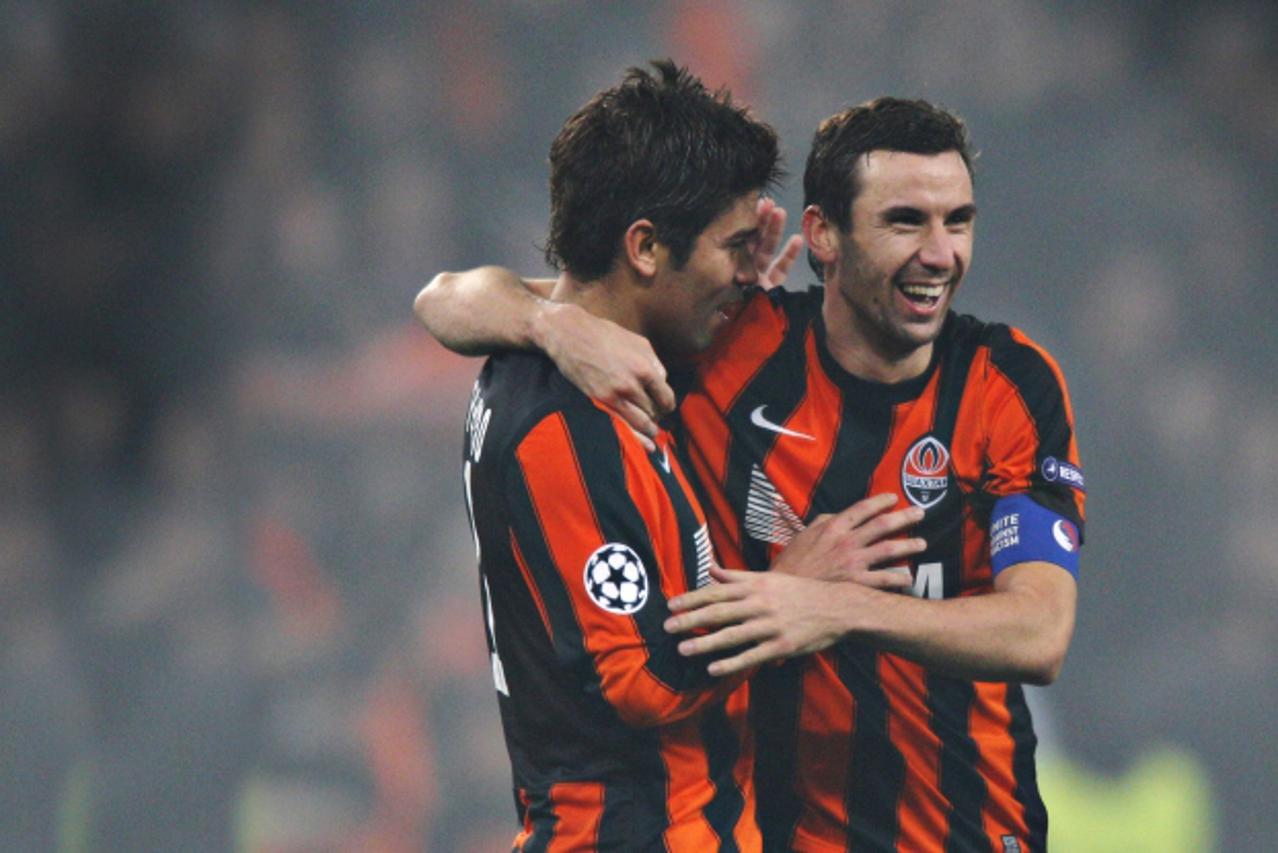 'Shakhtar Donetsk\'s forward Eduardo, left, and midfielder Darijo Srna celebrating the team\'s 2-1 win over Arsenal in the UEFA Champions League\'s group stage match.'