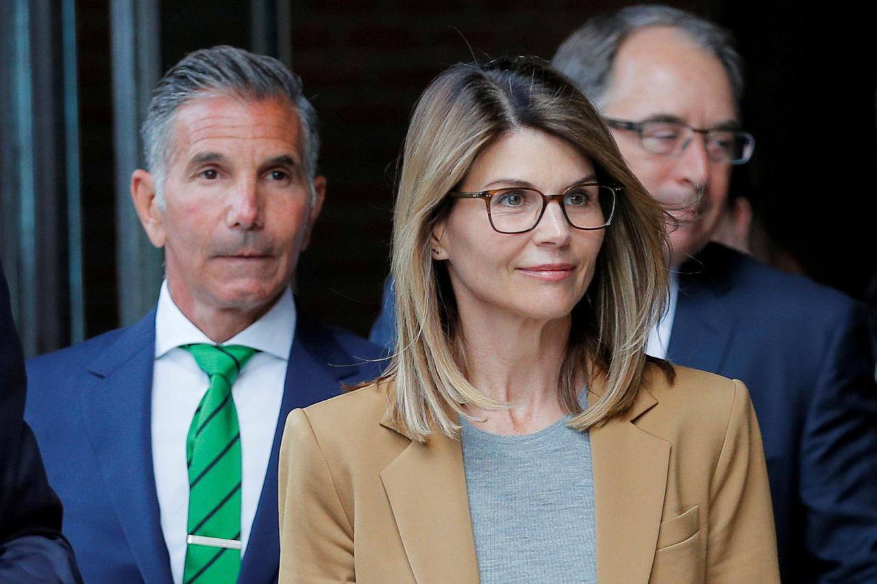 FILE PHOTO: Actress Lori Loughlin, and her husband, fashion designer Mossimo Giannulli leave the federal courthouse after a hearing on charges in a nationwide college admissions cheating scheme in Boston