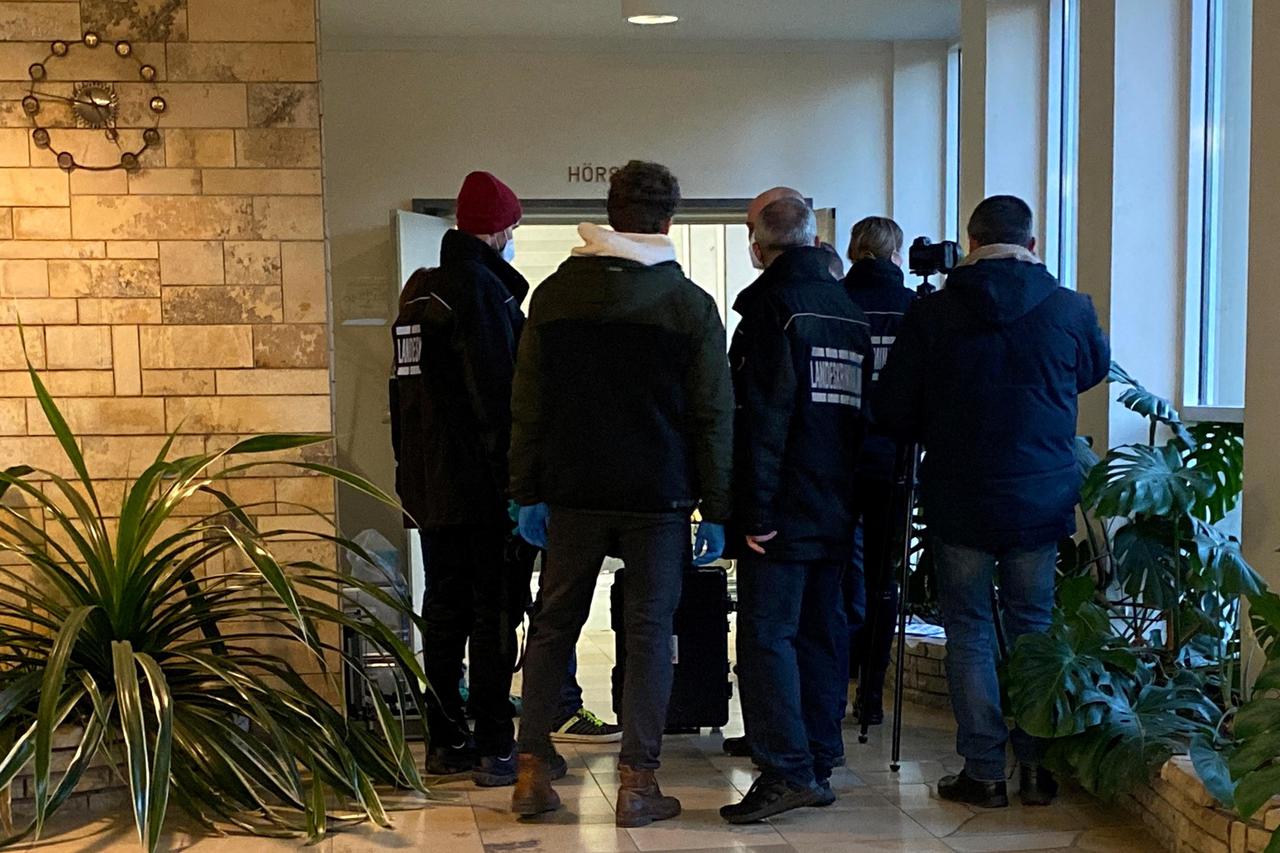 Police wait inside a building of the Heidelberg university