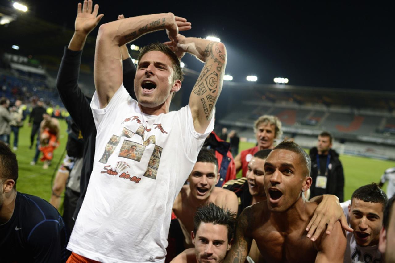 'Montpellier\'s French forward Olivier Giroud celebrates with teammates as Montpellier team won the French L1 football championship, after the French L1 football match Auxerre vs Montpellier, on May 2