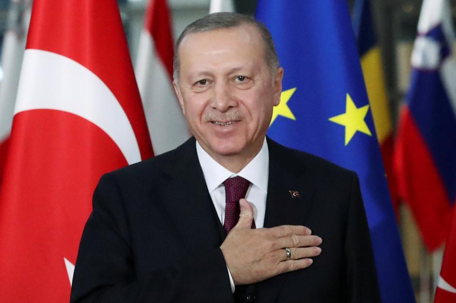 FILE PHOTO: Turkish President Tayyip Erdogan reacts ahead of a meeting with EU Council President Charles Michel pose in Brussels