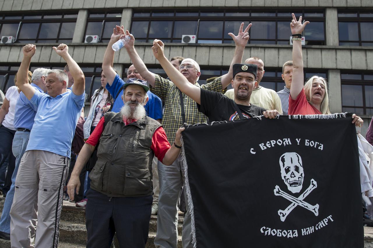Supporters of Dragoljub 'Draza' Mihailovic hold the 'Chetnik' fighters flag as they celebrate his rehabilitation in front of a court in Belgrade, Serbia, May 14, 2015. A Serbian court on Thursday rehabilitated World War Two royalist commander and convicte