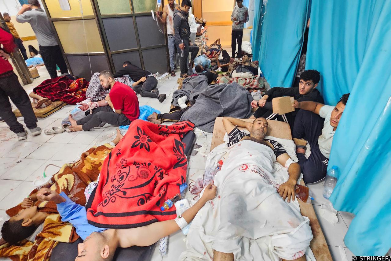 Palestinians wounded in Israeli strikes lie on the floor as they are assisted at the Indonesian hospital after Al Shifa hospital has gone out of service amid Israeli ground offensive