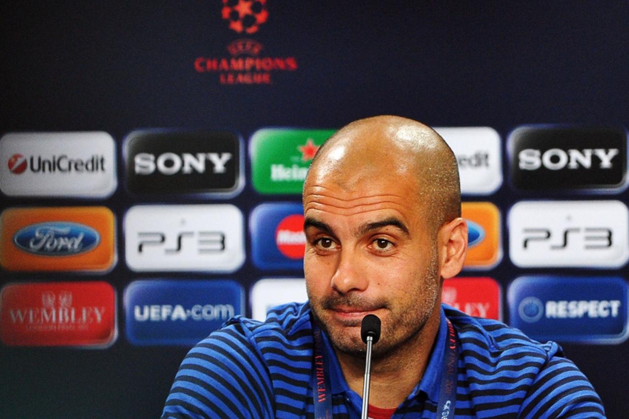 'FC Barcelona\'s Coach Josep Guardiola addresses a press conference ahead of the UEFA Champions League Final against Manchester United at Wembley Stadium on May 27, 2011 in London. FC Barcelona will p