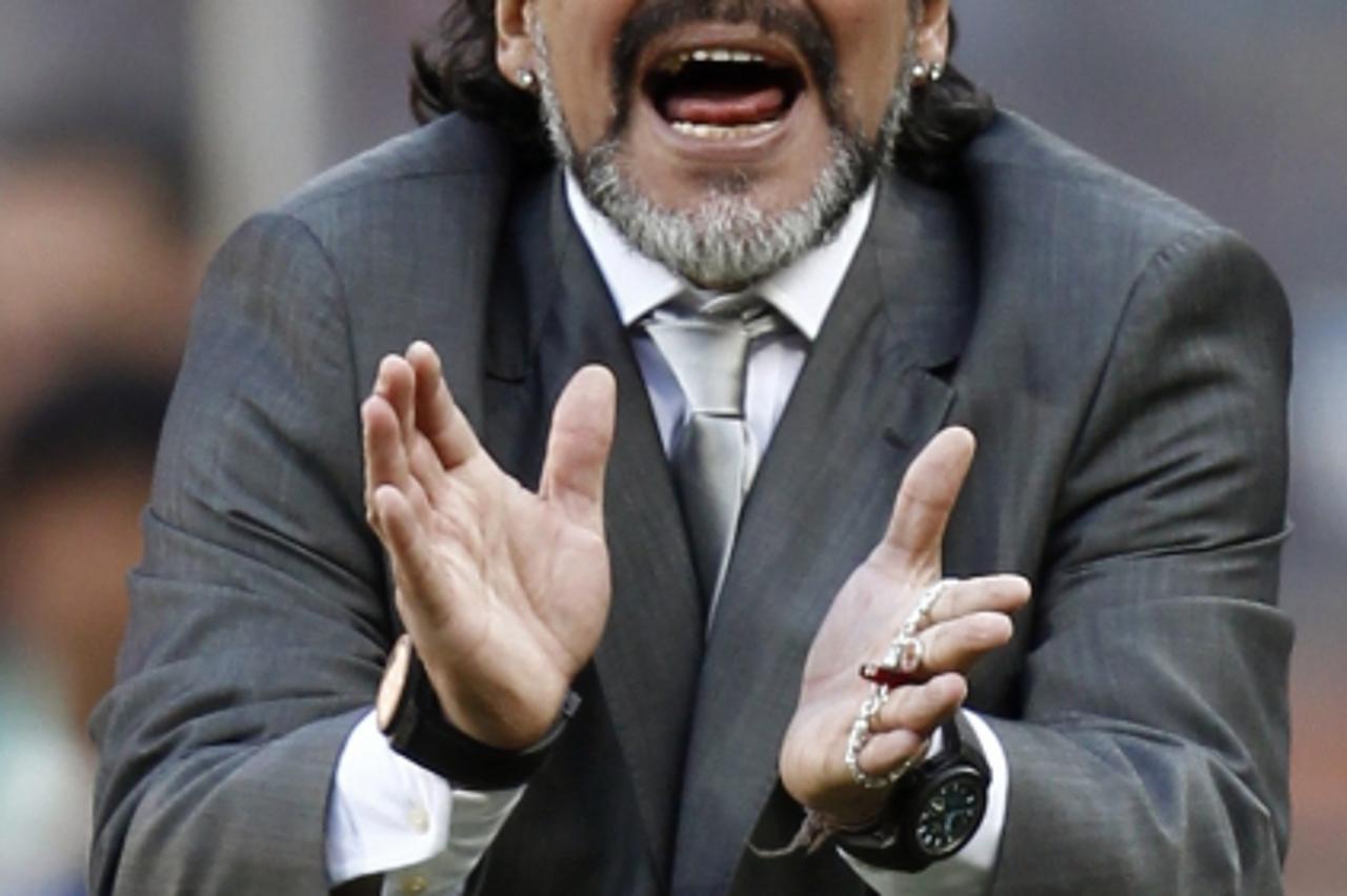 'Argentina\'s coach Diego Maradona celebrates after his team scored against South Korea during a 2010 World Cup Group B soccer match at Soccer City stadium in Johannesburg June 17, 2010.            RE