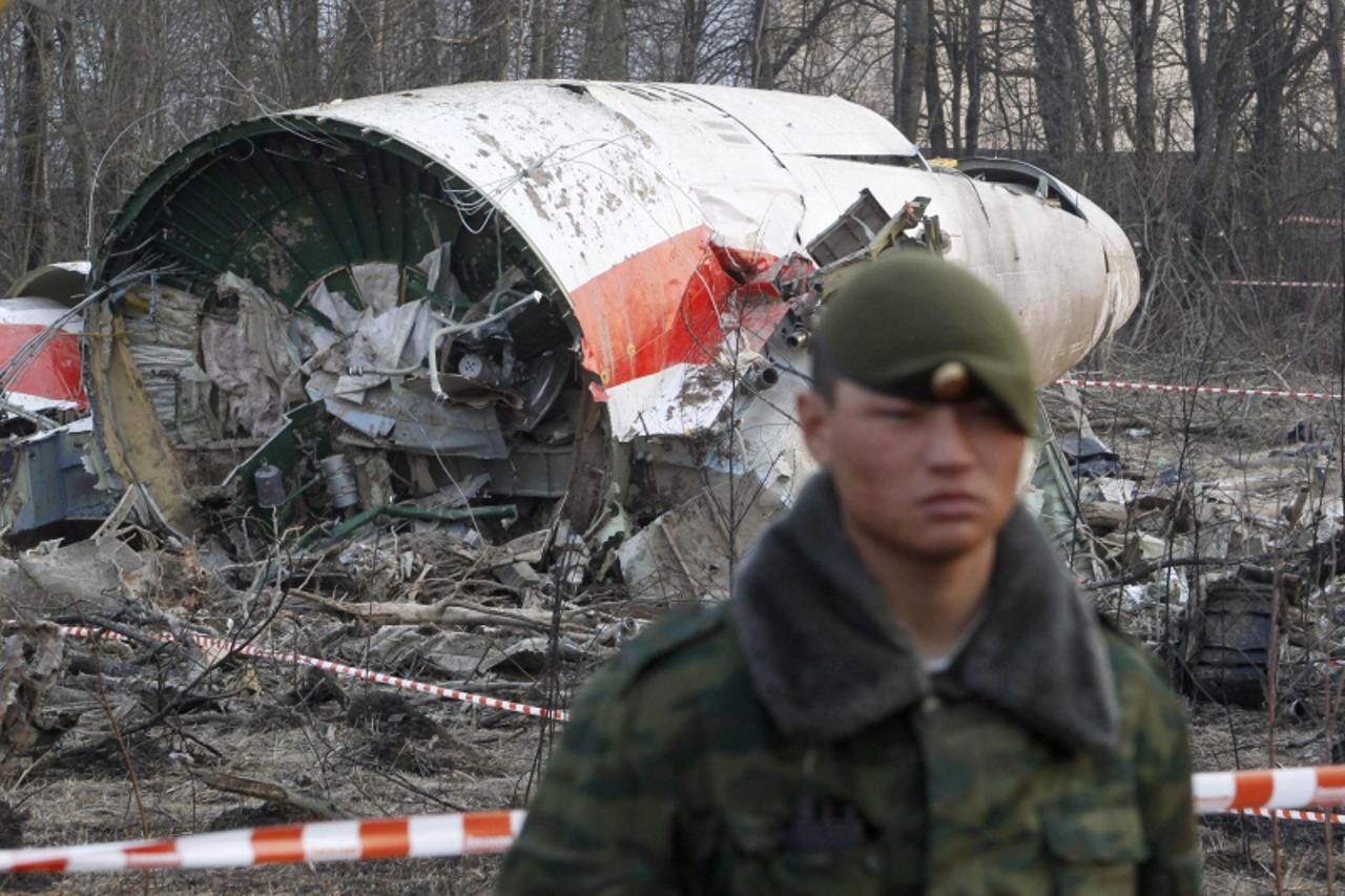 'A Russian serviceman stands guard near part of the wreckage of a Polish government TU-154 Tupolev aircraft that crashed near Smolensk airport in this April 11, 2010 file photo. Faulty equipment and p