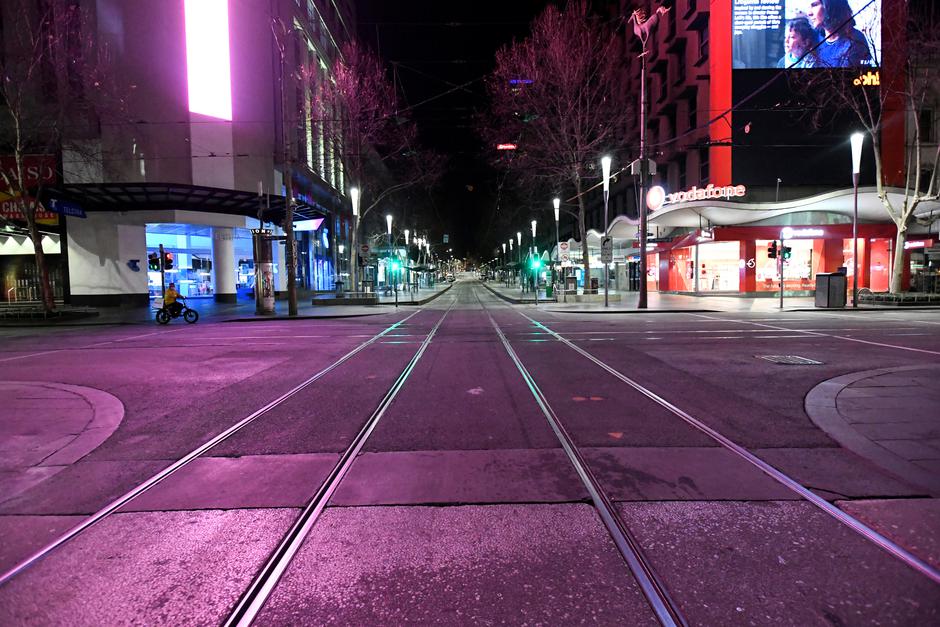 An empty street is seen after a citywide curfew was introduced to slow the spread of COVID-19 in Melbourne