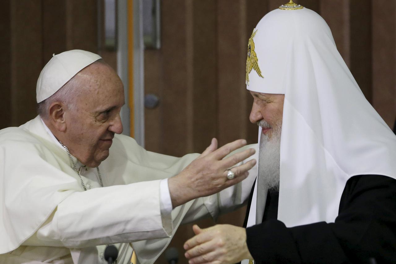 Pope Francis, left, reaches to embrace Russian Orthodox Patriarch Kirill after signing a joint declaration at the Jose Marti International airport in Havana, Cuba, Friday, February 12, 2016. REUTERS/Gregorio Borgia/Pool