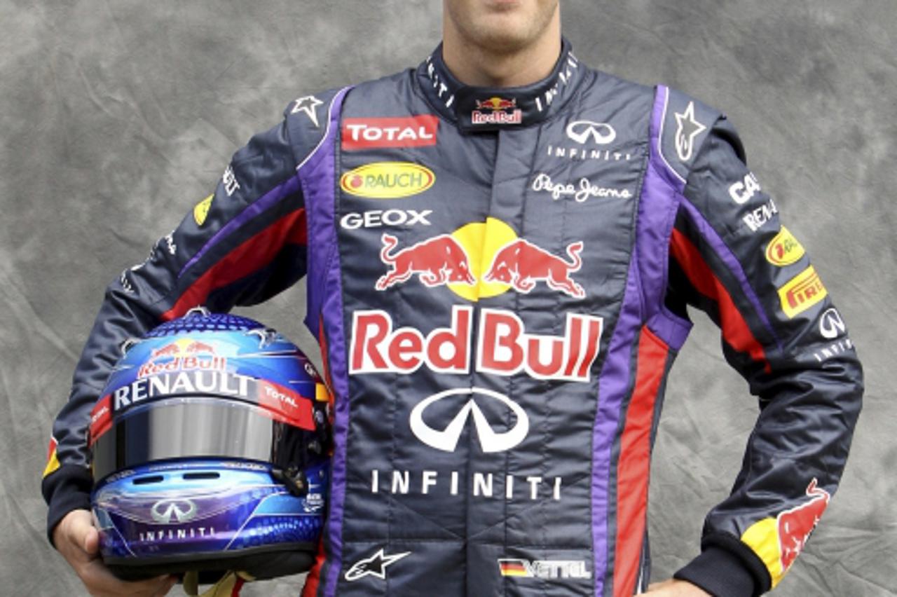 'Red Bull Formula One driver Sebastian Vettel of Germany poses for the official portrait at the Albert Park circuit in Melbourne March 14, 2013, ahead of the Australian F1 Grand Prix. REUTERS/Brandon 