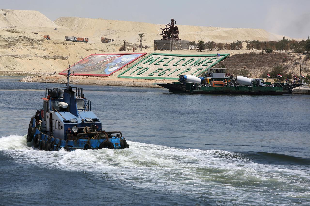 Security personnel cross through the New Suez Canal, Ismailia, Egypt, July 29, 2015. The first cargo ships passed through Egypt's New Suez Canal on Saturday in a test-run before it opens next month, state media reported, 11 months after the army began con