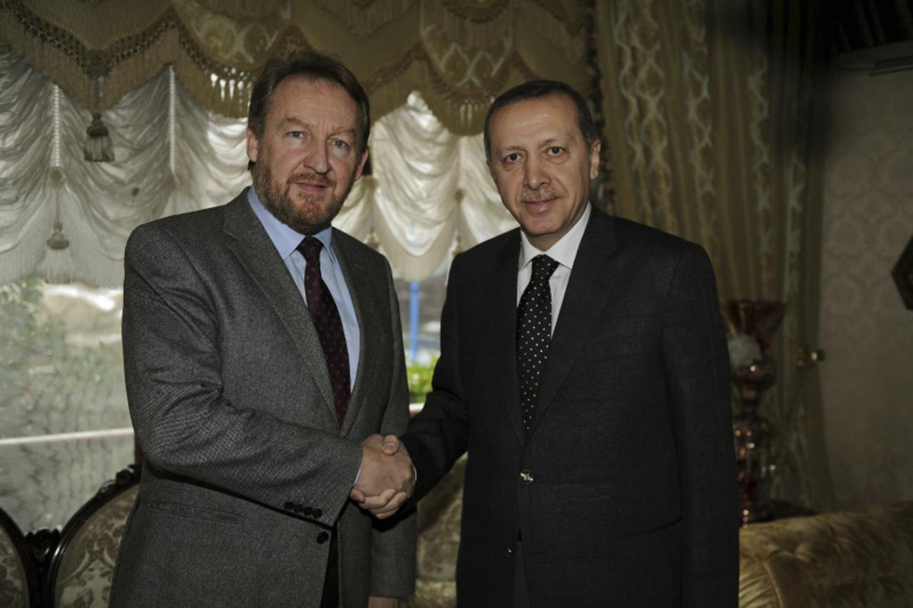 'Tripartite Bosnian Presidency member Bakir Izetbegovic (L) shakes hands with Turkey\'s Prime Minister Tayyip Erdogan at his residence in Istanbul February 16, 2012. REUTERS/Yasin Bulbul/Prime Ministe