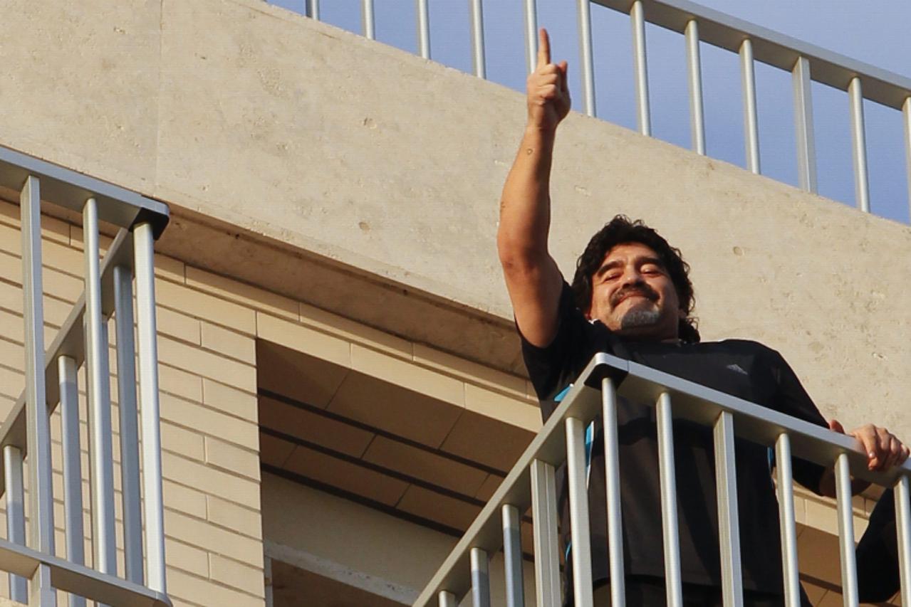 'Argentine former soccer star Diego Maradona gestures as he appears on a balcony in Naples February 25, 2013.  REUTERS/Ciro De Luca (ITALY - Tags: SPORT SOCCER)'