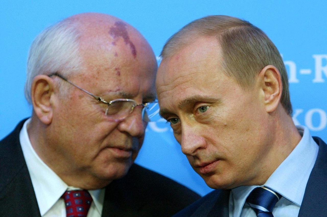 FILE PHOTO: Russian President Putin listens to former President of the Soviet Union Gorbachev during news conference in Schleswig