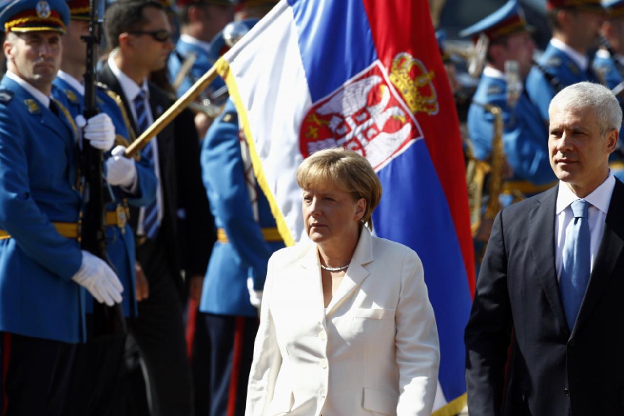 \'Serbia\'s President Boris Tadic (R) and German Chancellor Angela Merkel review a guard of honour before their meeting in Belgrade August 23, 2011. Merkel is on an official two-day visit to Serbia.  