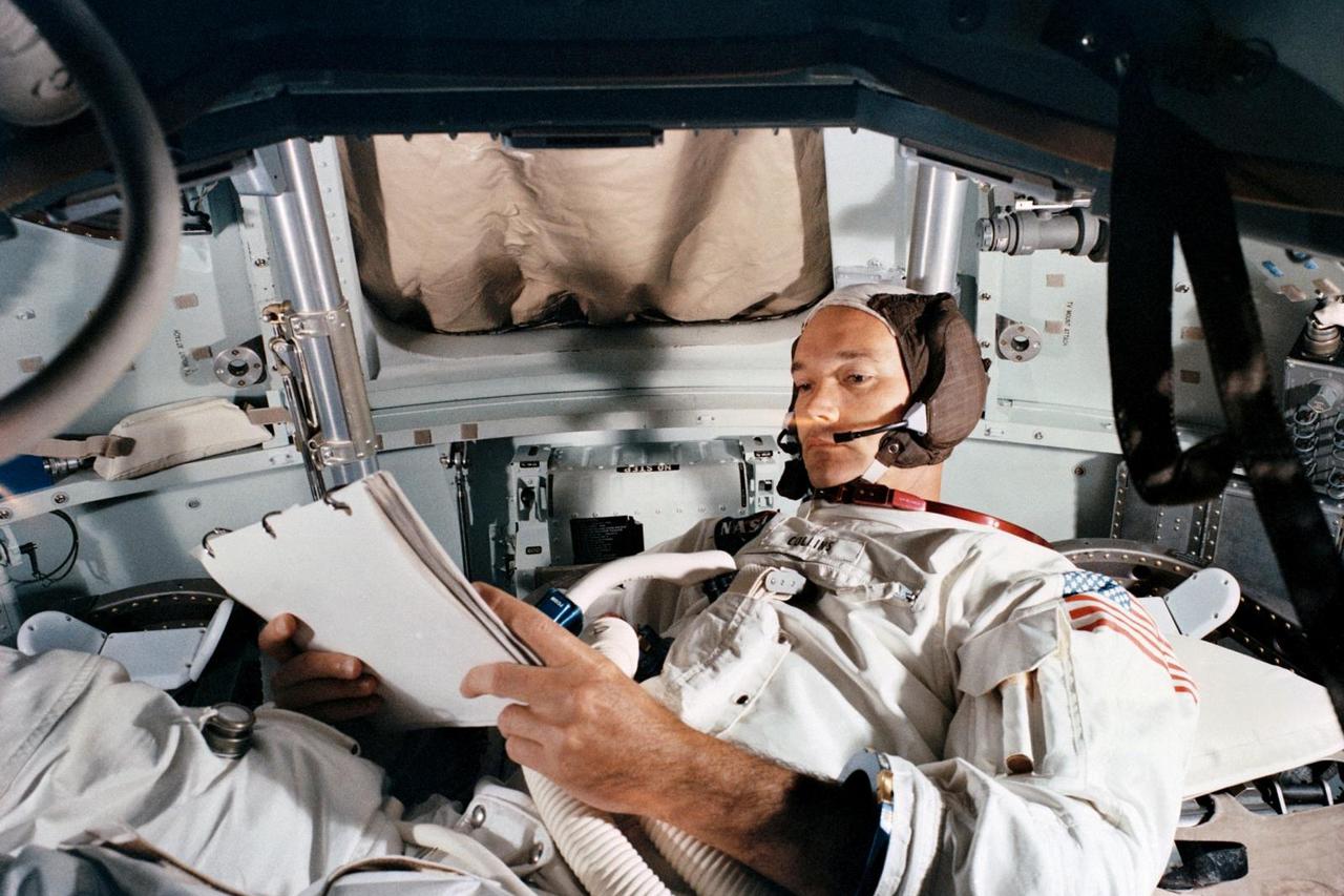 FILE PHOTO: Command Module pilot Michael Collins practices in the CM simulator at Kennedy Space Cente