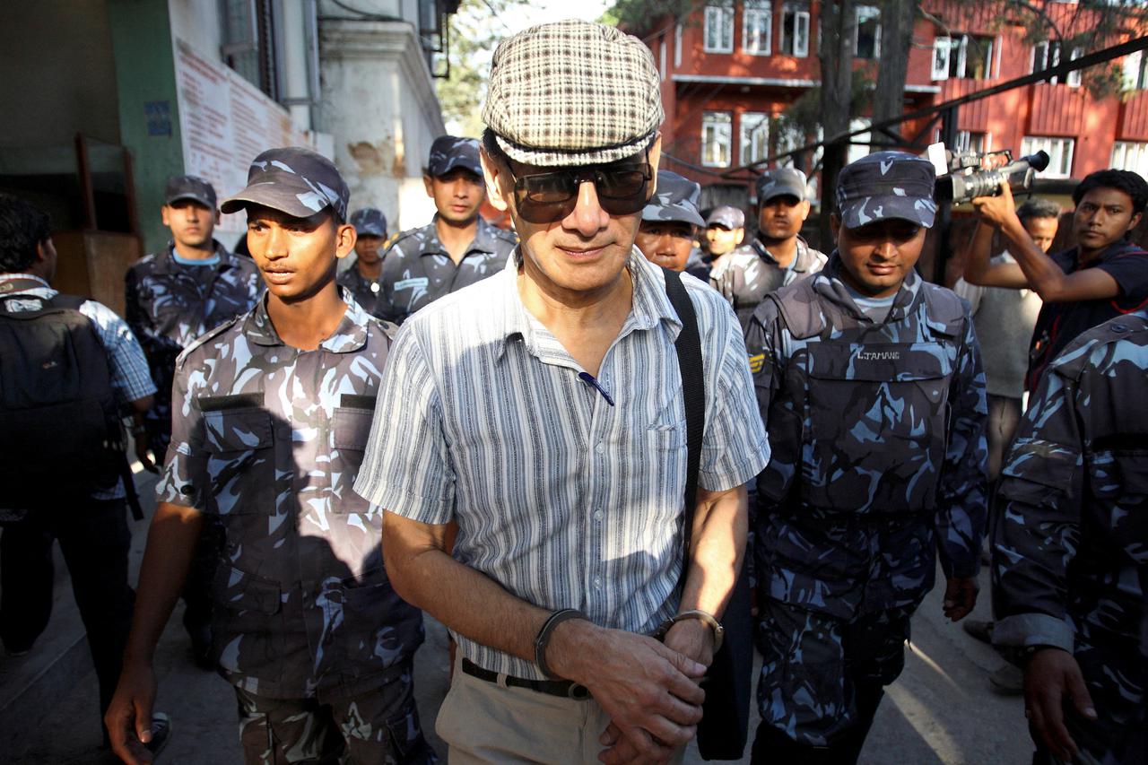 FILE PHOTO: French serial killer Charles Sobhraj leaves Kathmandu district court after his hearing in Kathmandu