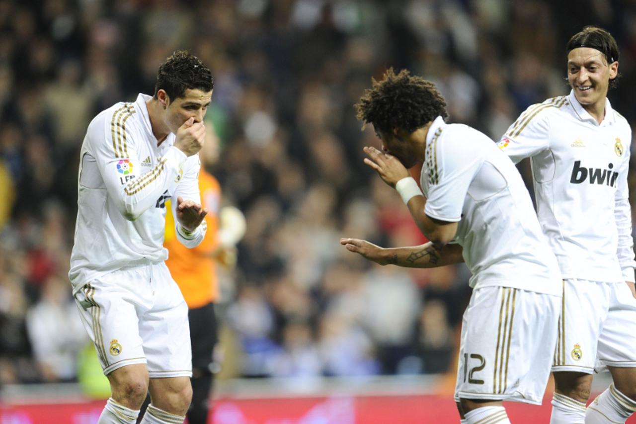 'Real Madrid\'s Portuguese forward Cristiano Ronaldo celebrates his goal with Real Madrid\'s Brazilian defender Marcelo (R) on March 4, 2012 during a Spanish league football match against Espanyol at 