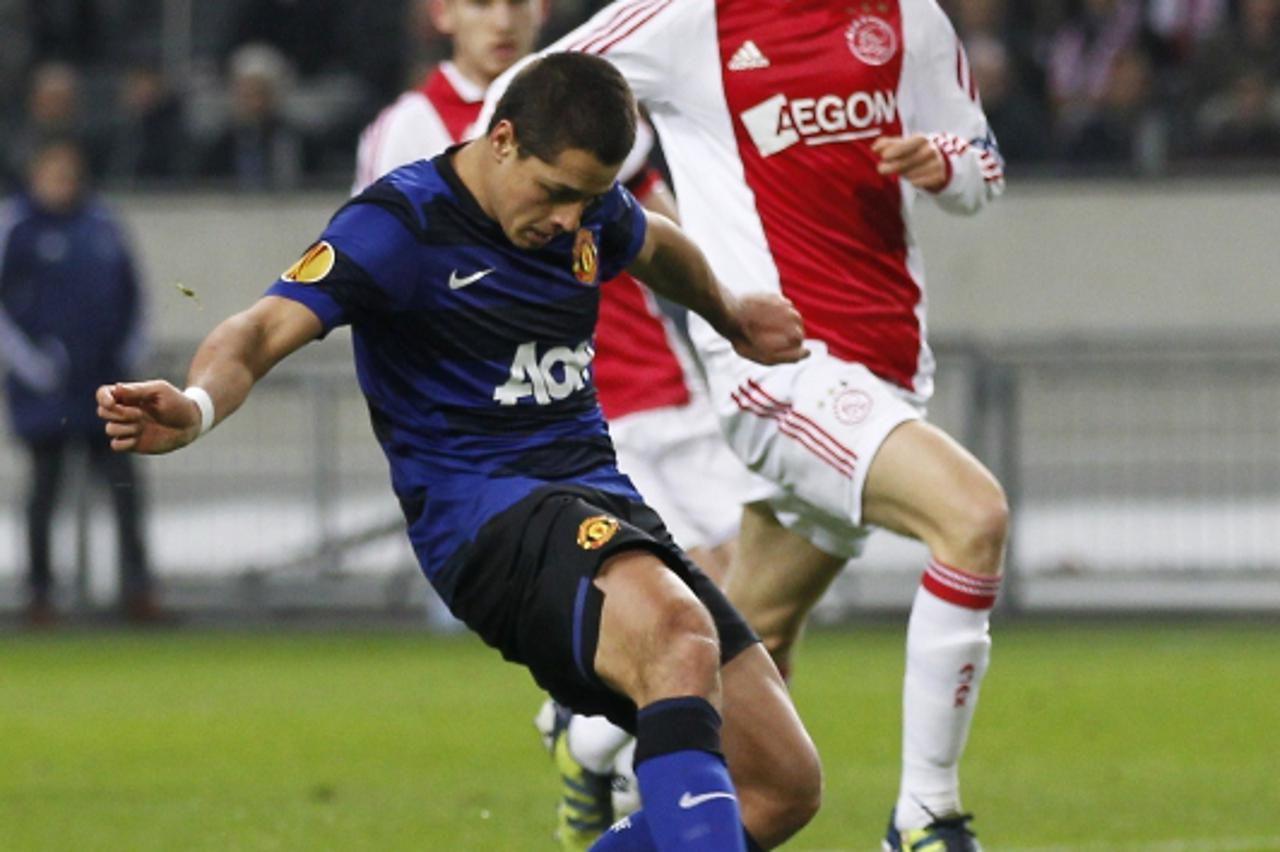 'Manchester United\'s Mexican player Javier Hernandez scores his goal during the UEFA Cup League, round of 16, football match between Ajax Amsterdam and Manchester United at the Amsterdam Arena in Ams