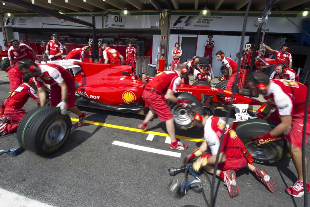 'The Ferrari crew practices the exchange tire operation at the team\'s pit on November 3, 2010 at Interlagos autodrome in Sao Paulo, Brazil. Alonso will participate in Brazil\'s F-1 GP next November 7