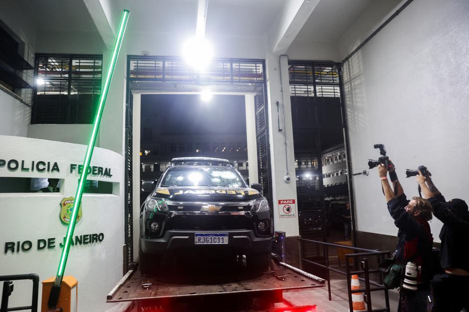 The federal police vehicle damaged after Brazilian politician Roberto Jefferson fired at police while resisting arrest ordered by the country's Supreme Court, arrives at the police headquarters in Rio de Janeiro