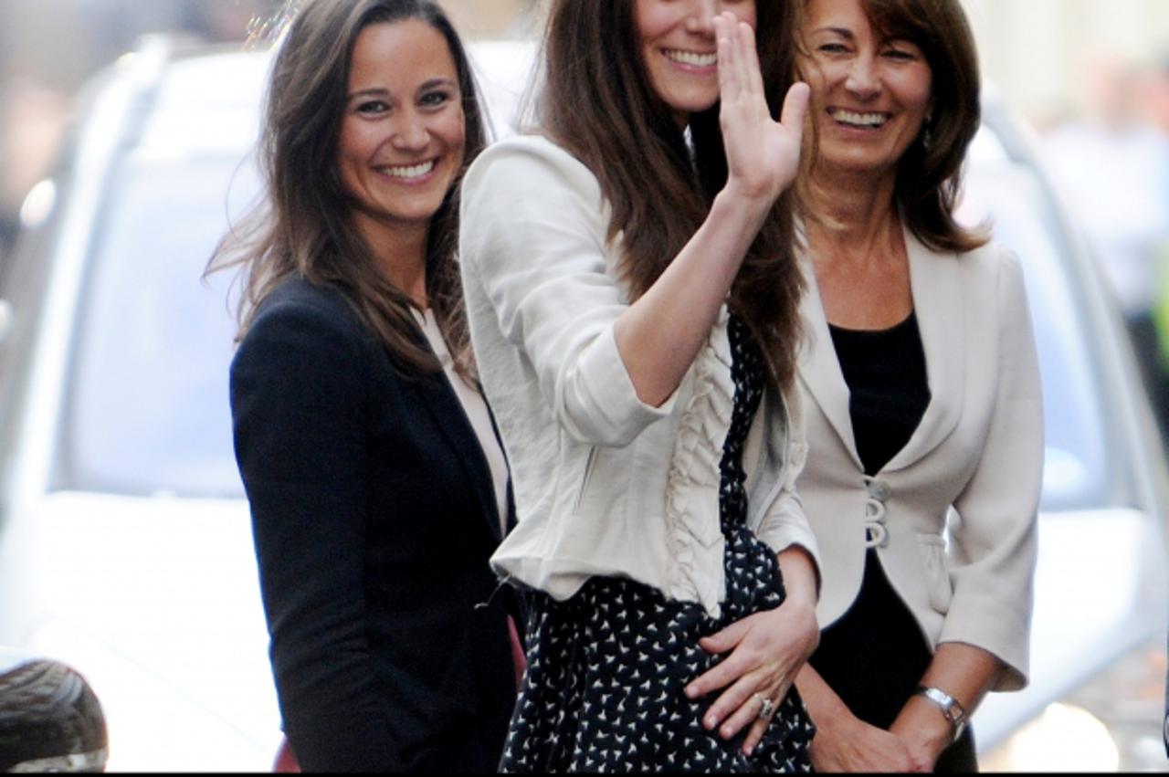 'Kate Middleton (M) waves to the crowd outside the Goring Hotel, London, Great Britain, 28 April 2011. She stands with her sister Pippa (L) and her mother Carole. London is preparing for the Royal Wed