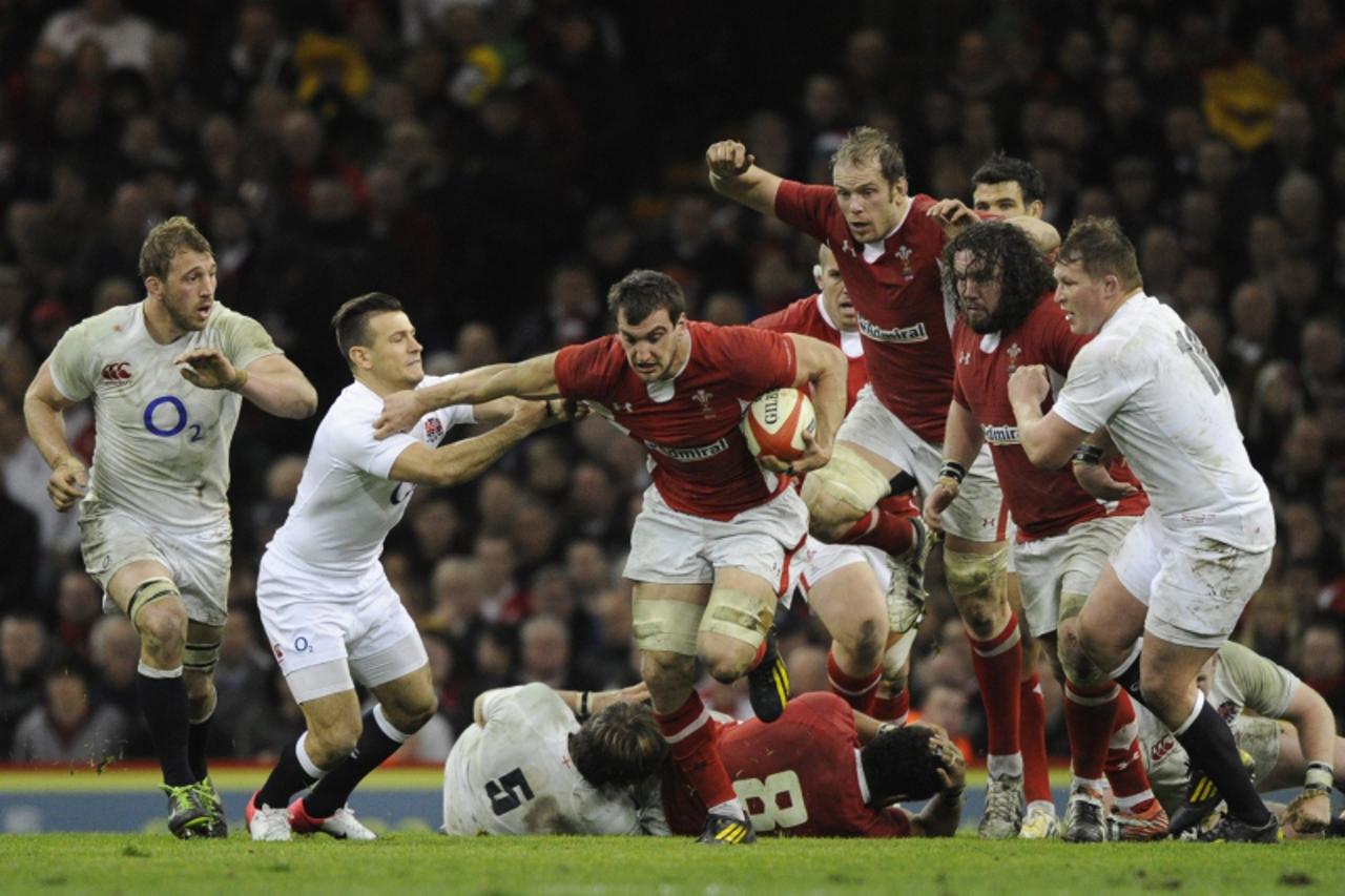 'Wales' Sam Warburton (C) runs with the ball during their Six Nations international rugby union match against England at the Millennium Stadium in Cardiff March 16, 2013.  REUTERS/Rebecca Naden (BRIT
