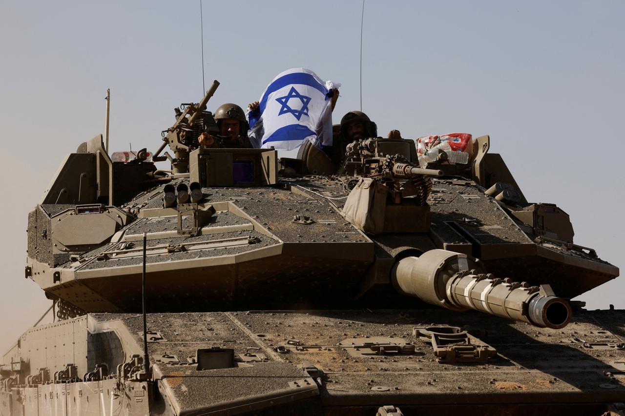 FILE PHOTO: Israeli soldiers operate near the border after leaving Gaza, during the temporary truce between the Palestinian Islamist group Hamas and Israel, in Israel