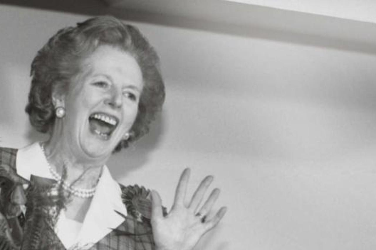 'Britain's Prime Minister Margaret Thatcher gives a jubilant wave from the stairs inside her Conservative party headquarters in London early in this June 12, 1987 file photo, after sweeping back to p