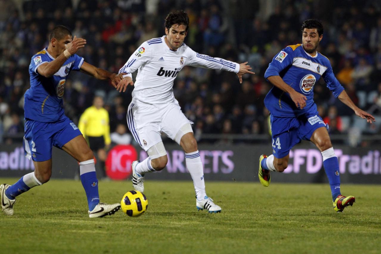 'Real Madrid\'s Kaka (C) is challenged by Getafe\'s Daniel Alberto Diaz (L) and Miguel Torres Gomez during their Spanish first division soccer league match at the Colisseum Alfonso Perez stadium in Ma