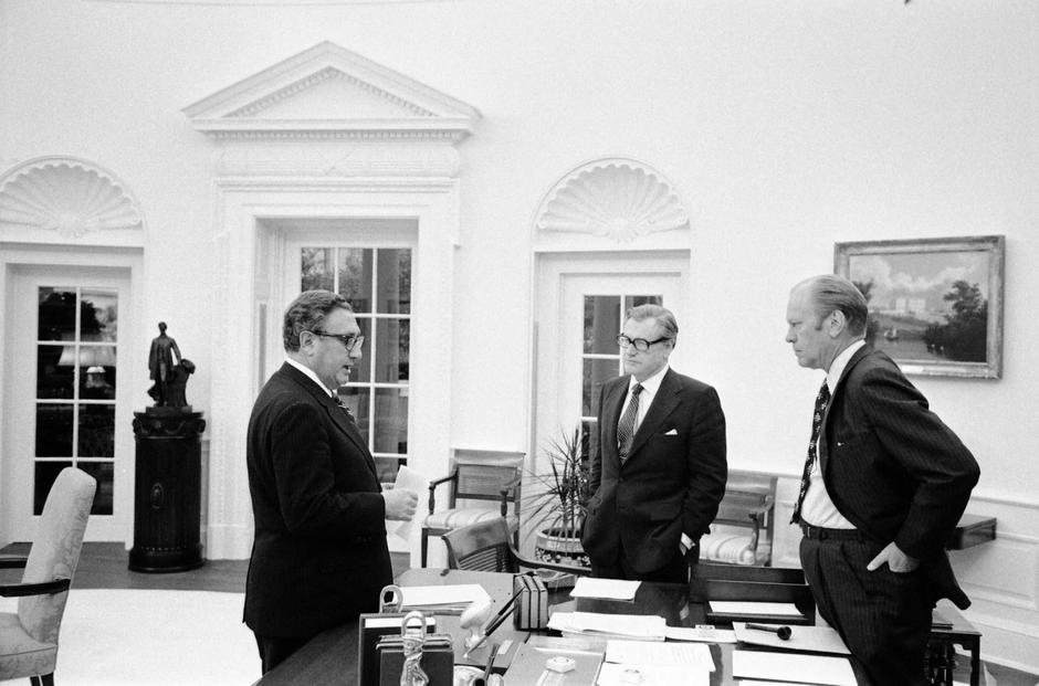 FILE PHOTO: U.S. President Gerald Ford, Nelson A. Rockefeller and Henry A. Kissinger stand around the Oval Office desk