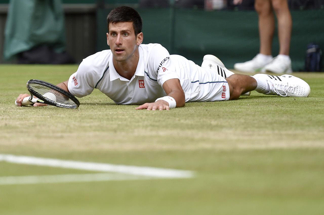 Novak Djokovic of Serbia after slipping during his Men's Singles Final match against Roger Federer of Switzerland at the Wimbledon Tennis Championships in London, July 12, 2015.                                                     REUTERS/Toby Melville