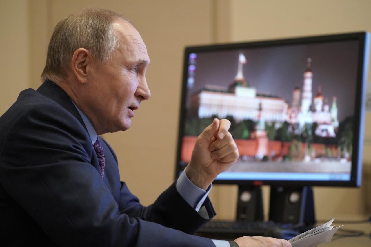 Russian President Vladimir Putin speaks during a video conference call outside Moscow